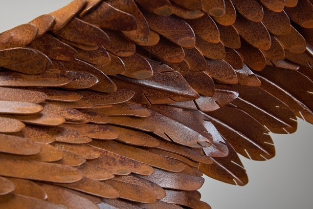 Layered hand-hammered wing feathers with corrosion patina