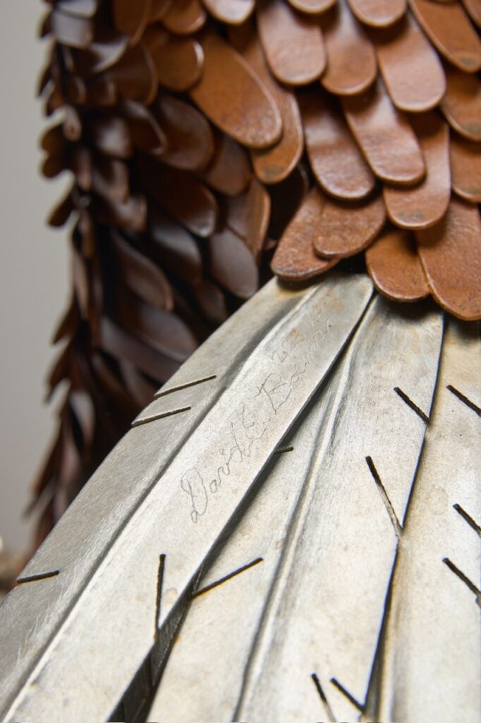 Close-up of hand-hammered eagle feathers with patina